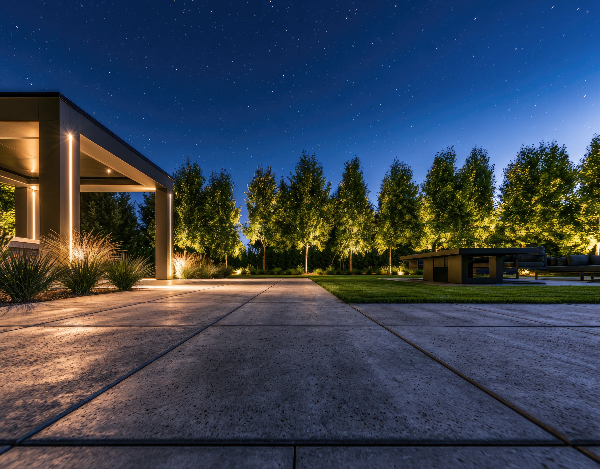Large concrete patio and outdoor living area at night