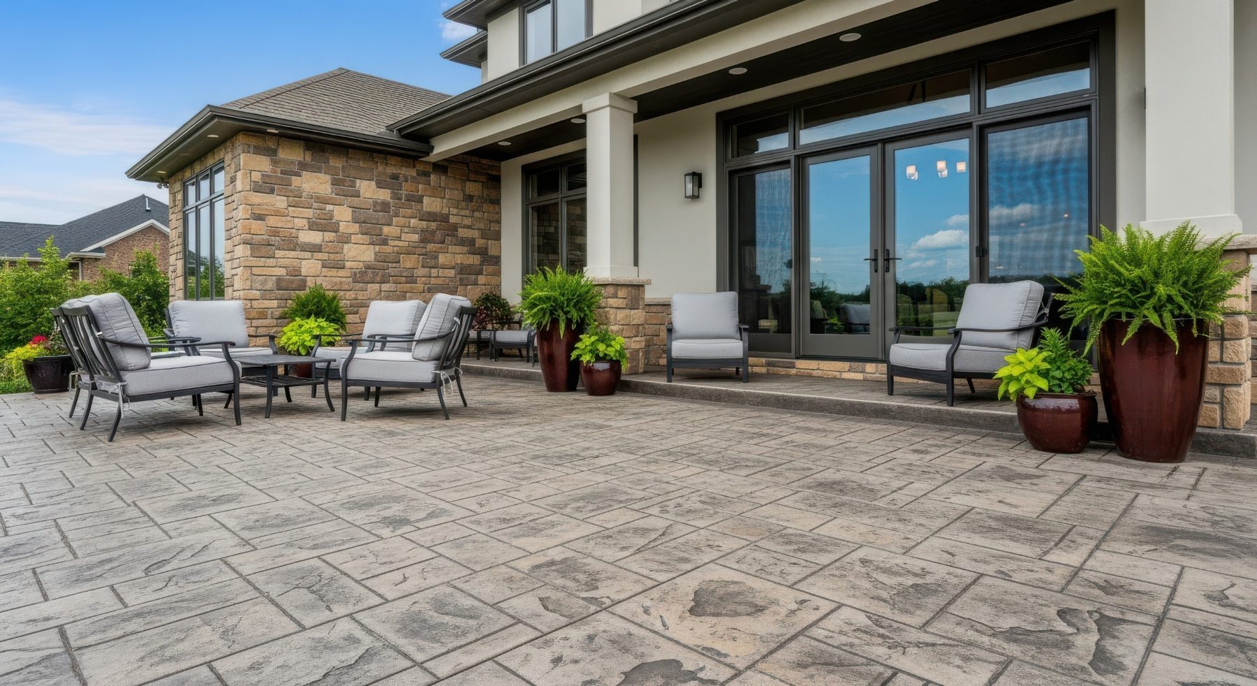 Stamped decorative concrete patio at a landscaped residential home